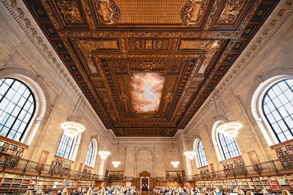Library reading room with rows of bound volumes under subdued natural light